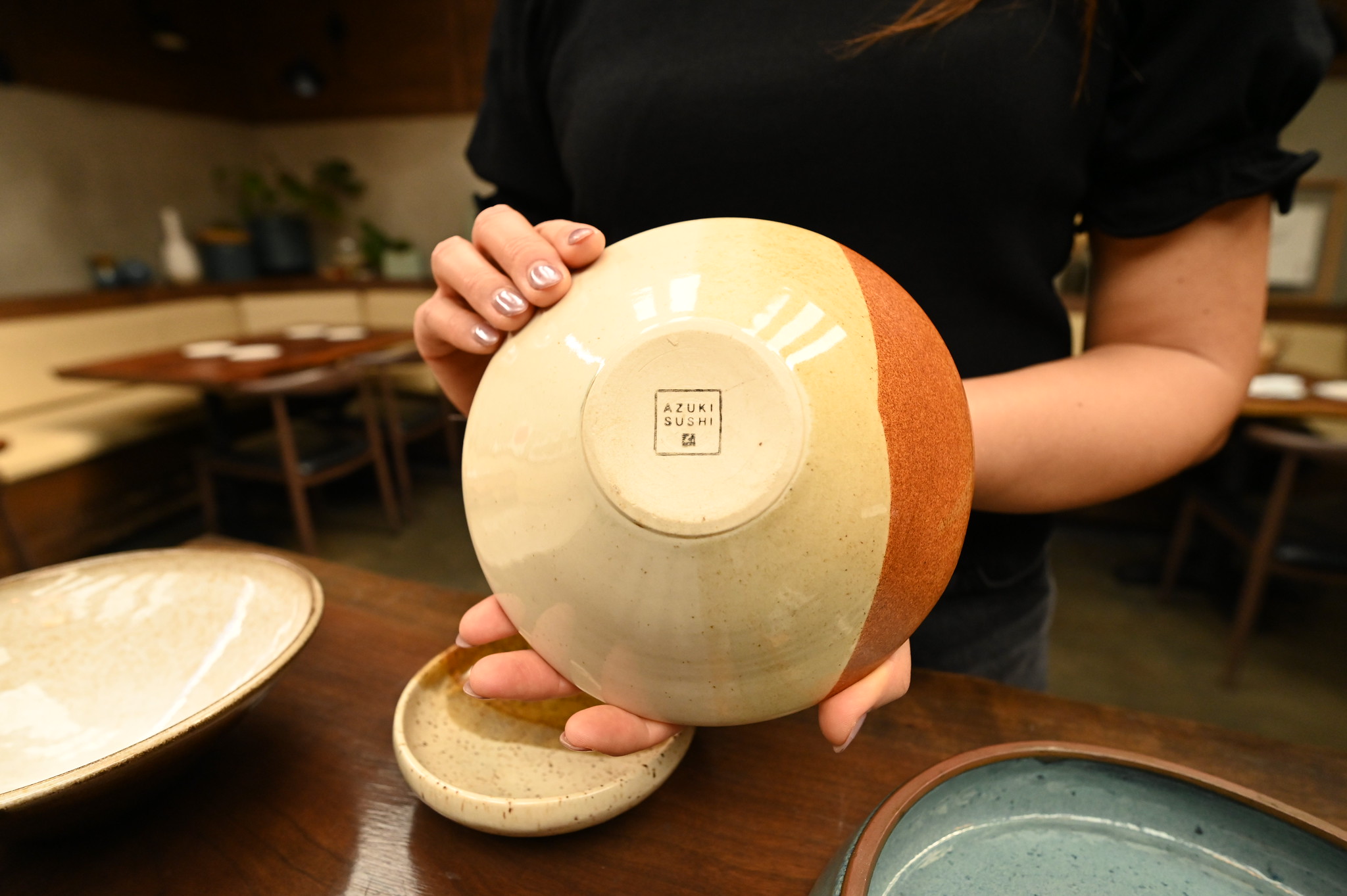 Borillo displays the Azuki Sushi maker's mark stamped on the bottom of a student-made bowl.