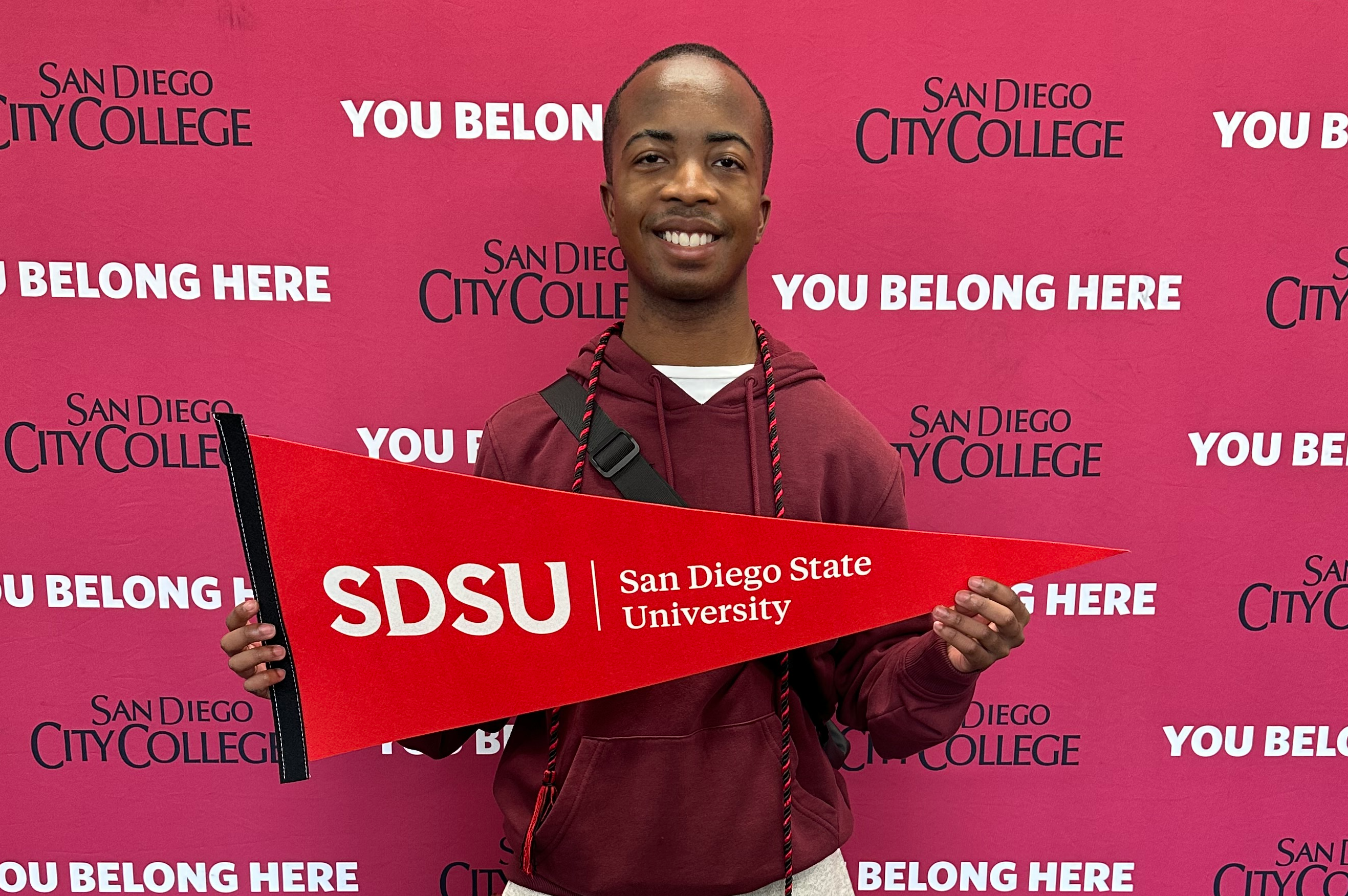 Student holding SDSU pennant