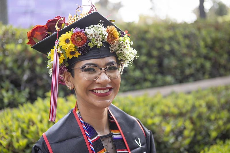 Students with flowers in graduation cap