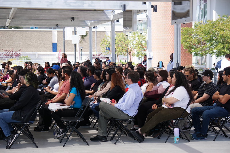 a patio event with people facing the presenter